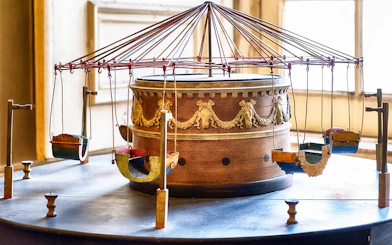 Ancient carousel model at Royal Palace of Caserta with ornate design.