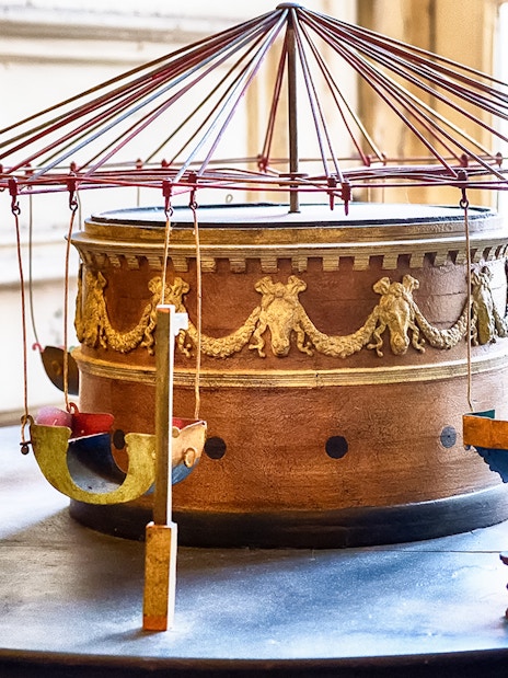 Ancient carousel model at Royal Palace of Caserta with ornate design.