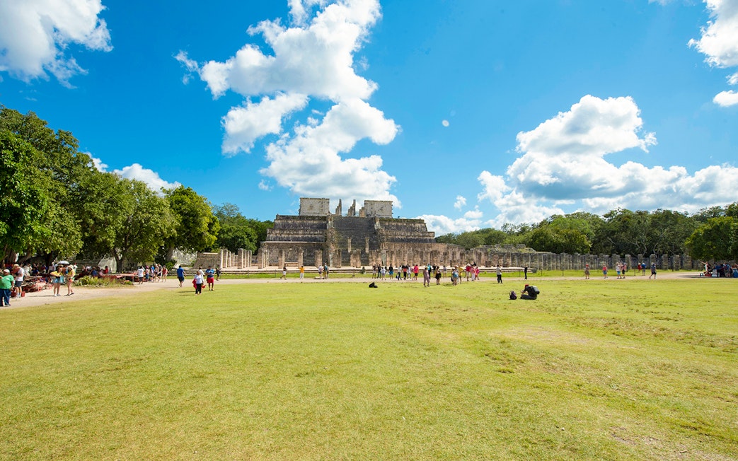 Tourists exploring the Temple of the Warriors at Chichén Itzá, Yucatán.