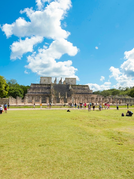 Tourists exploring the Temple of the Warriors at Chichén Itzá, Yucatán.