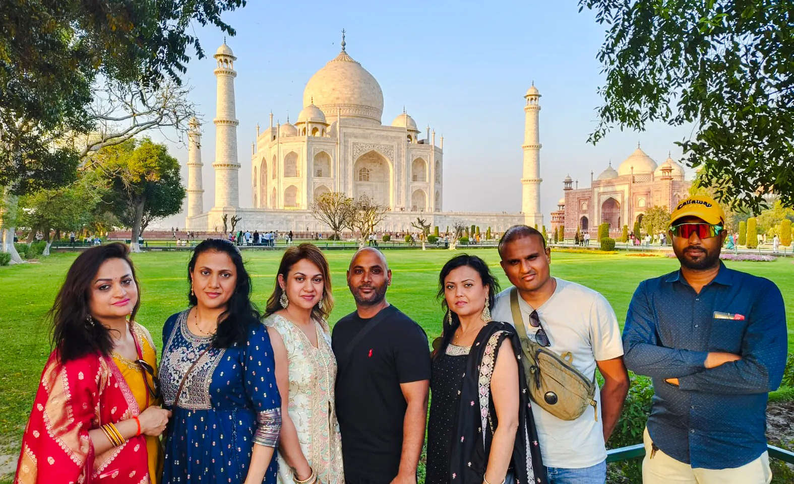 Group of tourists in front of the Taj Mahal during a guided tour in Agra.