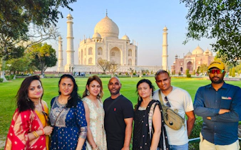 Group of tourists in front of the Taj Mahal during a guided tour in Agra.