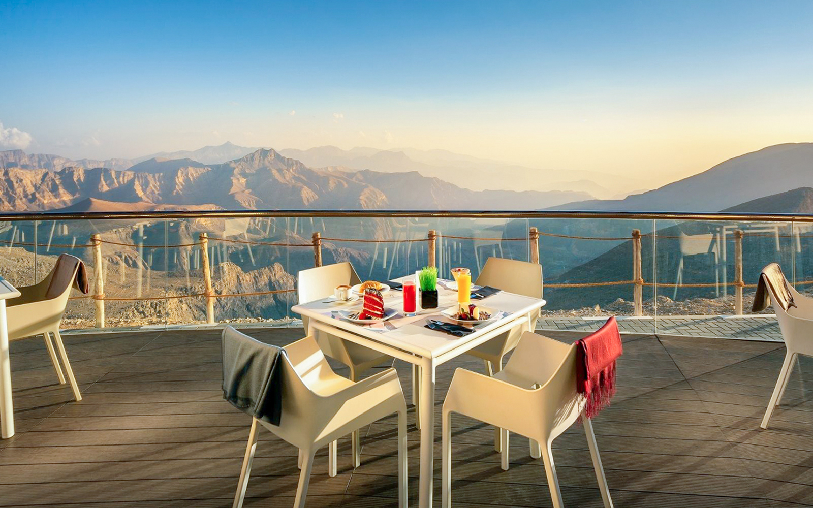 Table seating at Puro restaurant with a view of the Jebel Jais mountains