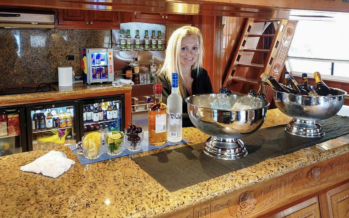 Bar setup with drinks and bartender on Northern Lights Yacht cruise.