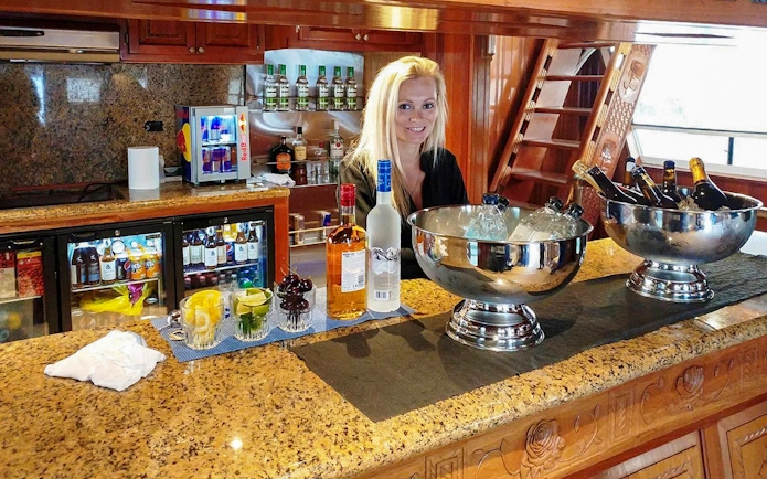 Bar setup with drinks and bartender on Northern Lights Yacht cruise.