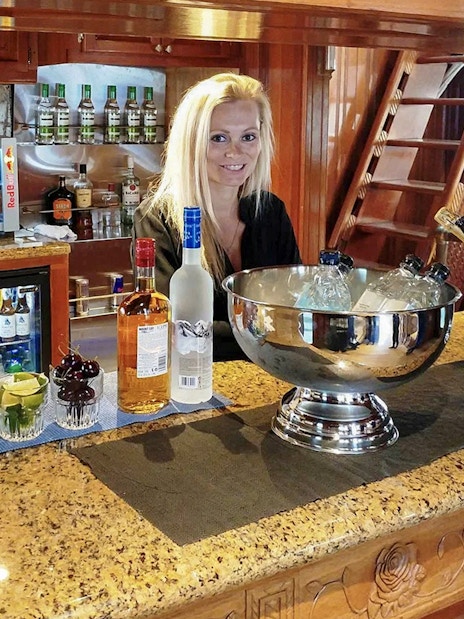 Bar setup with drinks and bartender on Northern Lights Yacht cruise.