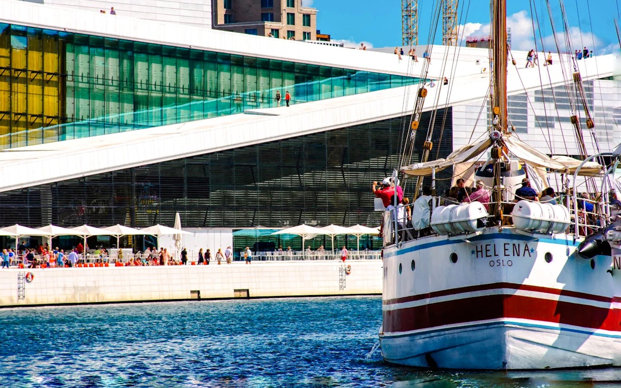 Sailing ship near Oslo Opera House, Norway, with people on deck.
