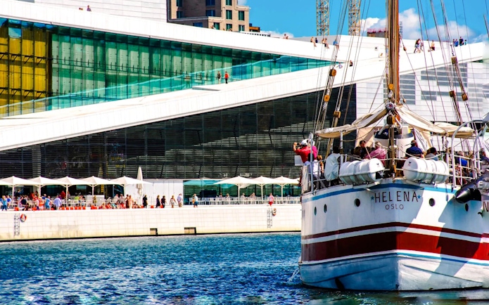 Sailing ship near Oslo Opera House, Norway, with people on deck.