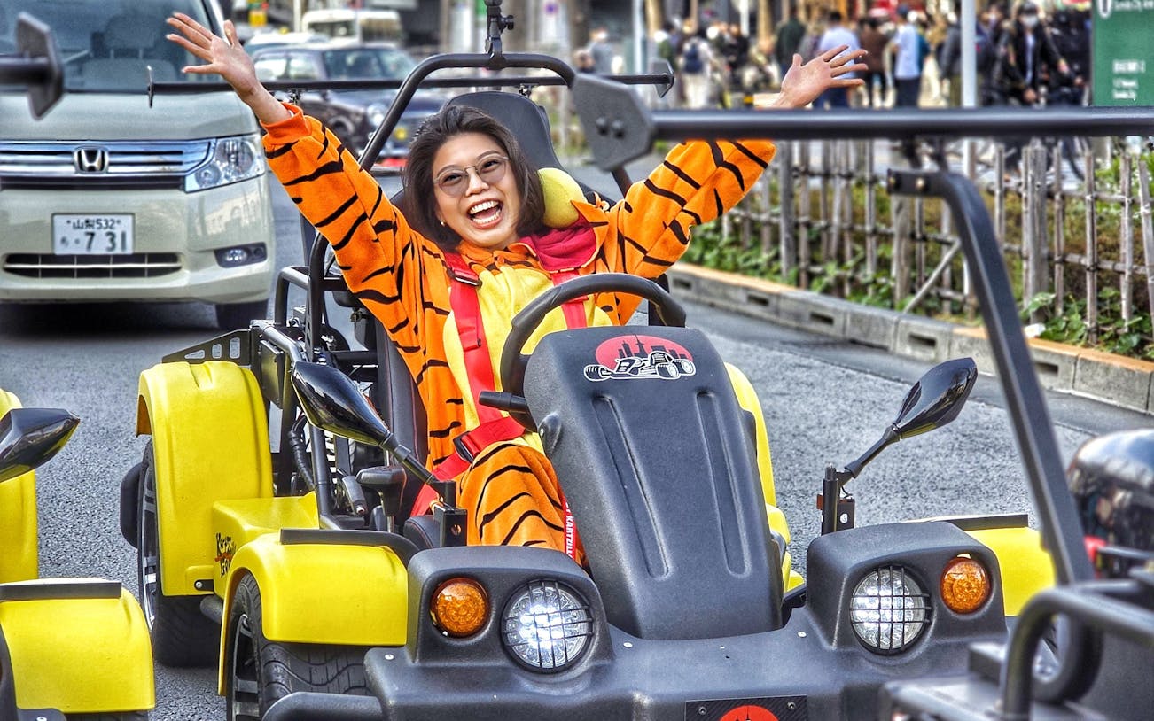 Person in costume driving a go-kart on Tokyo street during Old Town tour.