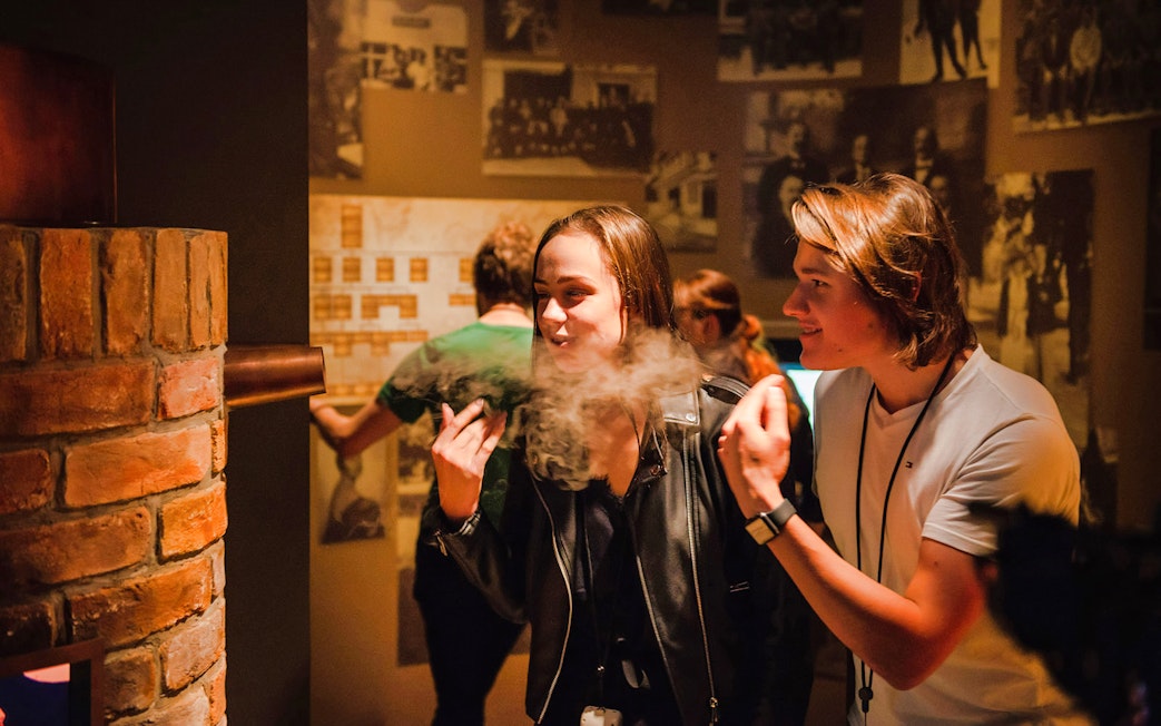 Visitors enjoying plum brandy tasting at Slivovitz Museum with 5D VR experience.