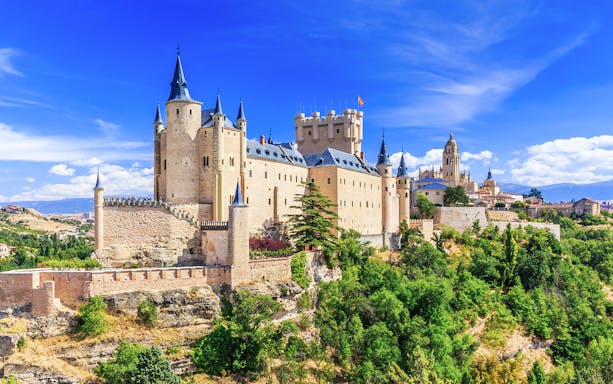 I don't know who is in the image, but it shows the Alcázar of Segovia, a historic castle in Spain.
