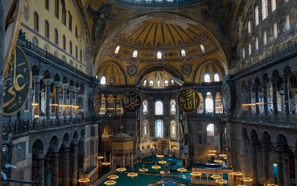 Hagia Sophia interior with ornate domes and Islamic calligraphy, Istanbul.