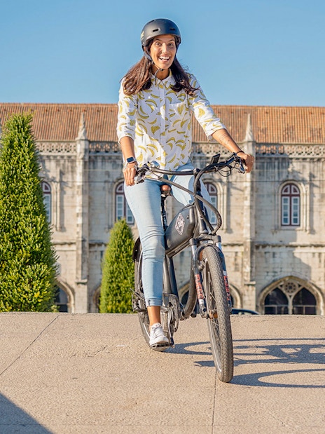 Cyclists enjoying Lisbon e-bike tour near historic Belém landmark.