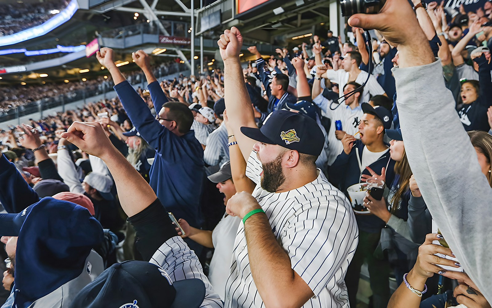 Fans cheering at a New York Yankees vs Milwaukee Brewers game, Yankee Stadium, September 8, 2023.