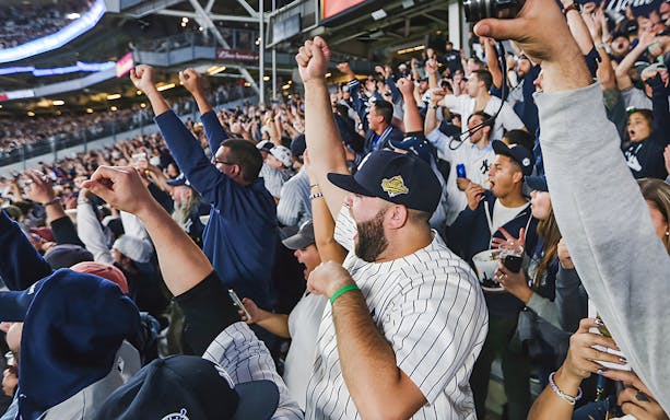Fans cheering at a New York Yankees vs Boston Red Sox game, June 10, 2023.