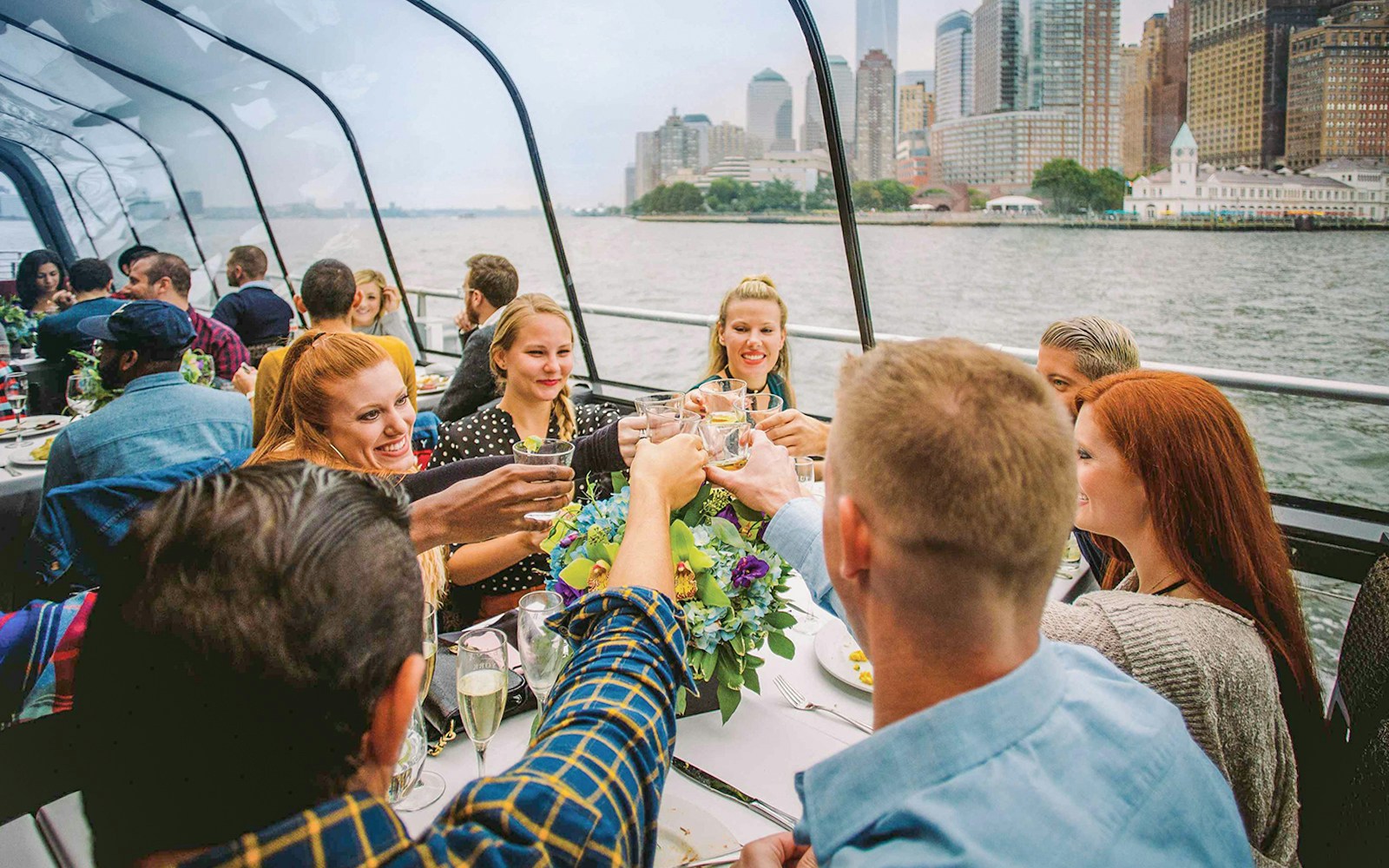 Family enjoying a New York lunch cruise on Bateaux New York with skyline views.