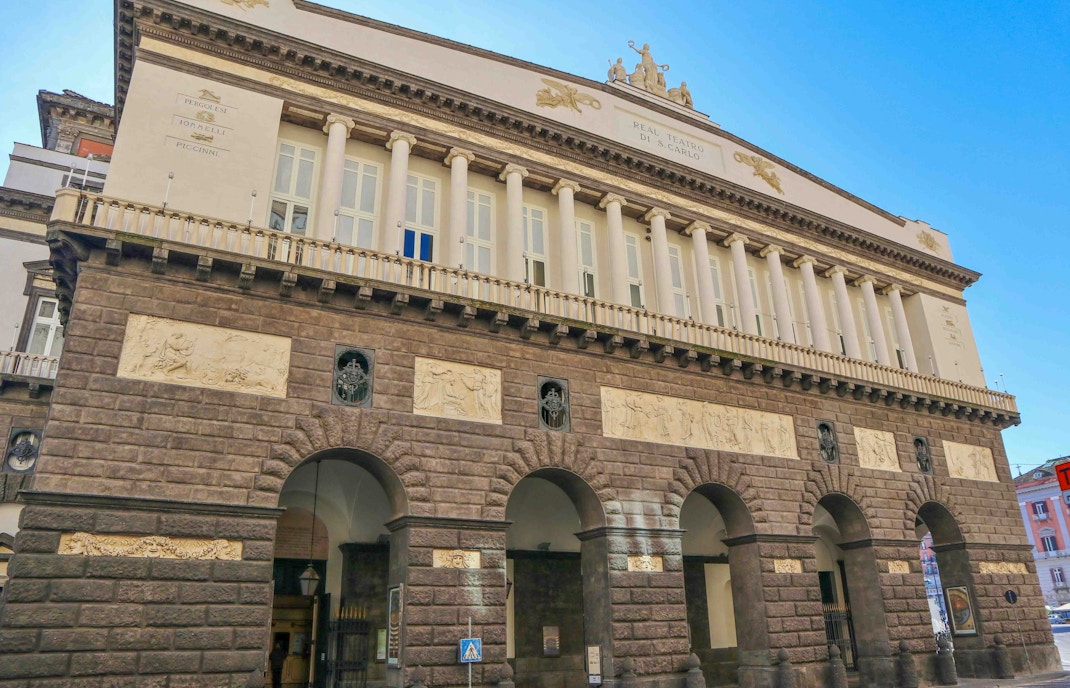 Teatro San Carlo facade with arches and classical columns in Naples, Italy.