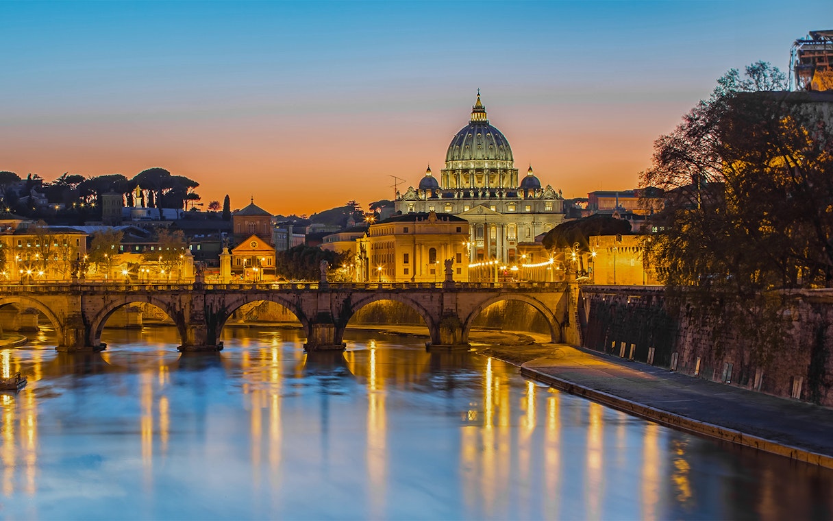 St. Peter's Basilica and Tiber River at sunset, Rome night bus tour.