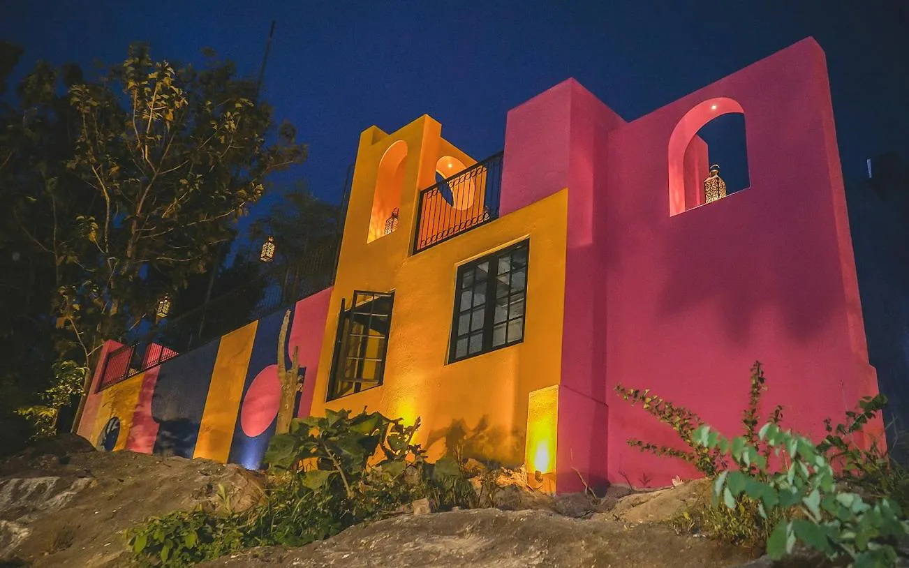 Colorful building with vibrant pink and yellow walls in Dubai, part of All Inclusive Pass tour.