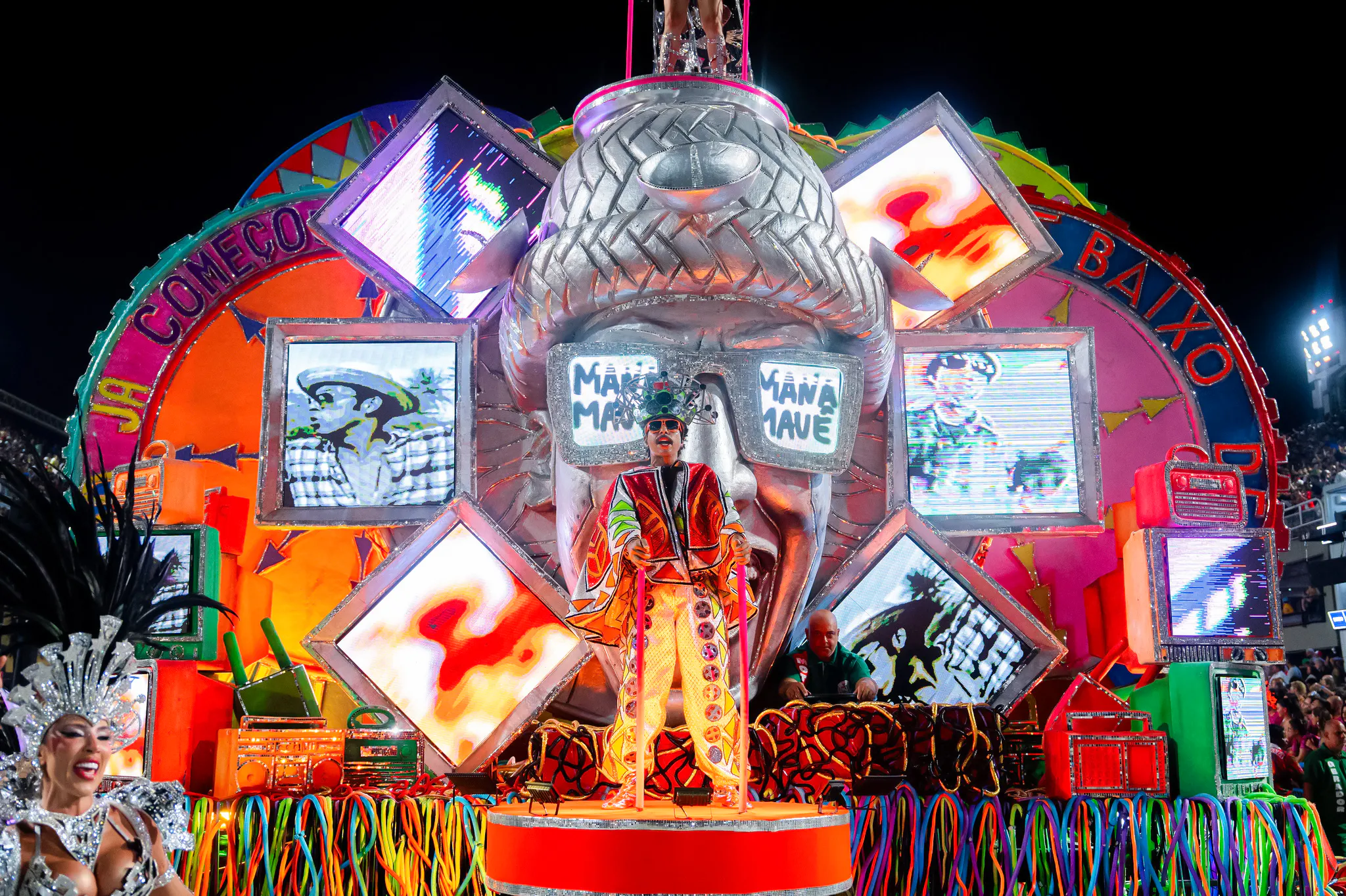 Colorful carnival float with performers and vibrant decorations during a festival in Genoa.