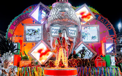 Colorful carnival float with performers and vibrant decorations during a festival in Genoa.