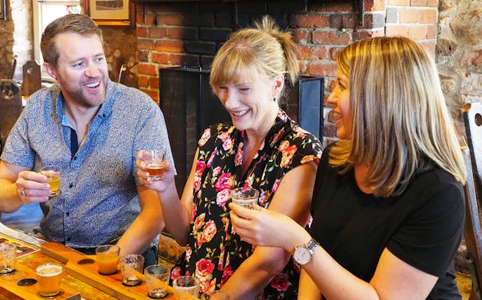 Group enjoying beer tasting in Adelaide Hills pub.