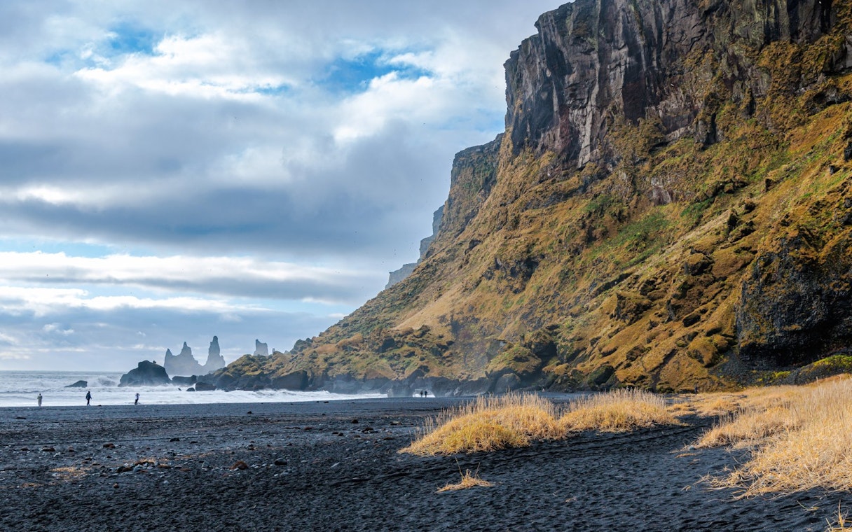 Vikurfjara Black Sand Beach with Reynisdrangar sea stacks near Vik, Iceland.
