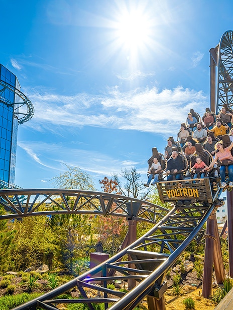 Rollercoaster riders on the Voltron Nevera in Croatia-themed area under a sunny sky.