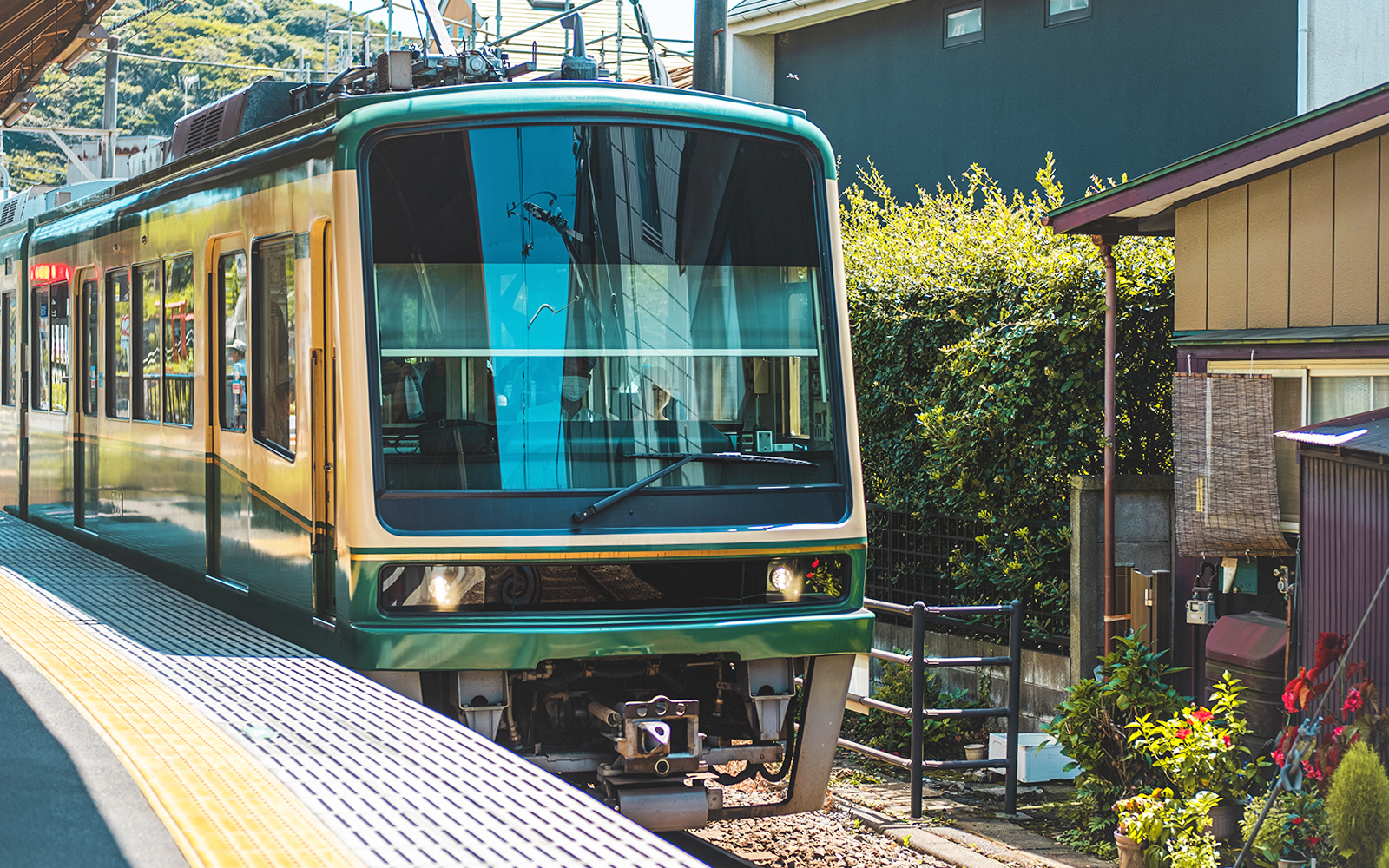 Enoden tram at a station in Kamakura during a 1-day guided tour.