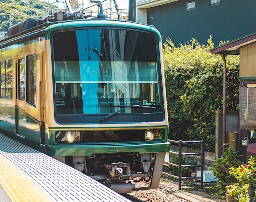 Enoden tram at a station in Kamakura during a 1-day guided tour.
