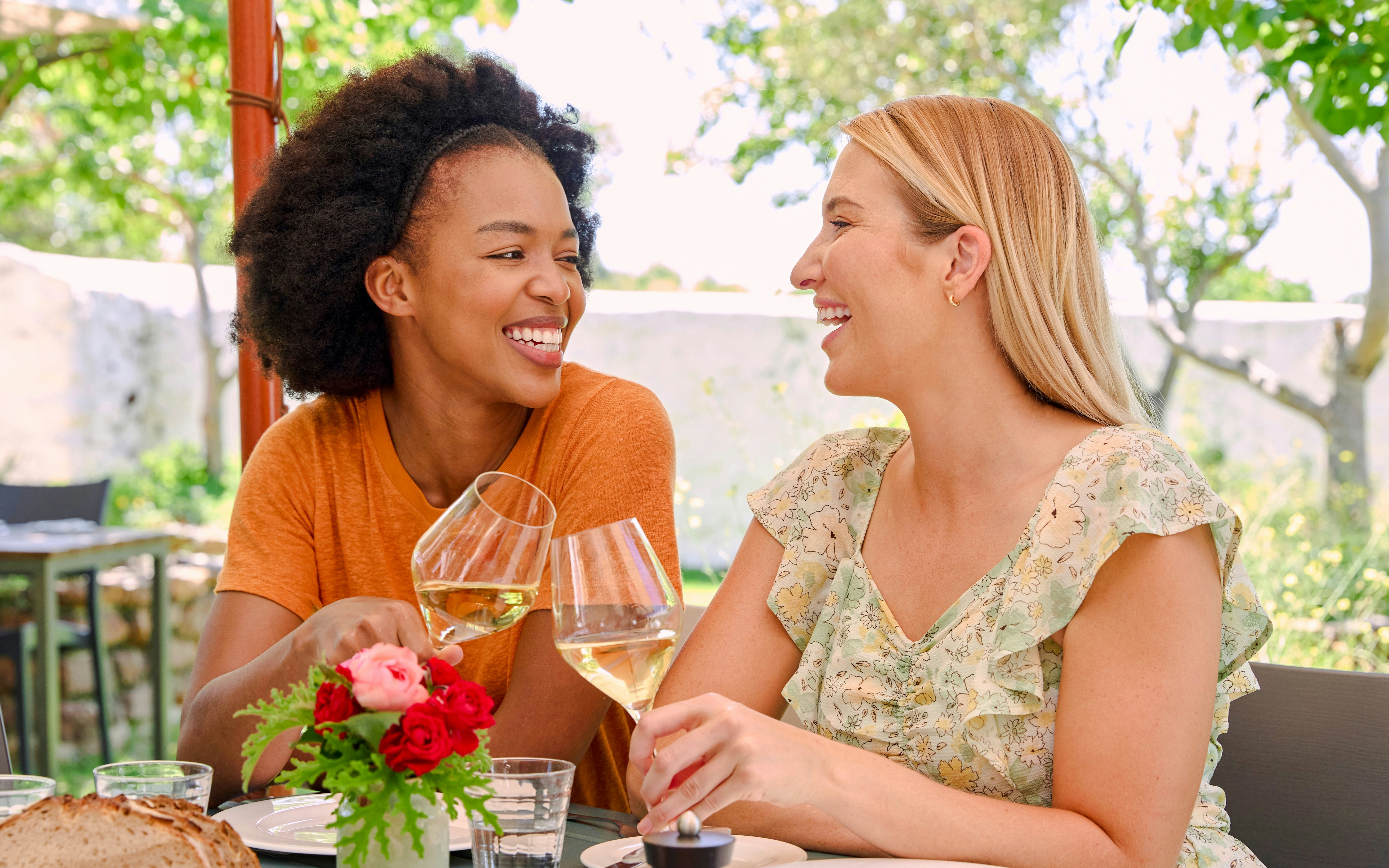 Couple enjoying wine at Vineyard Restaurant table.