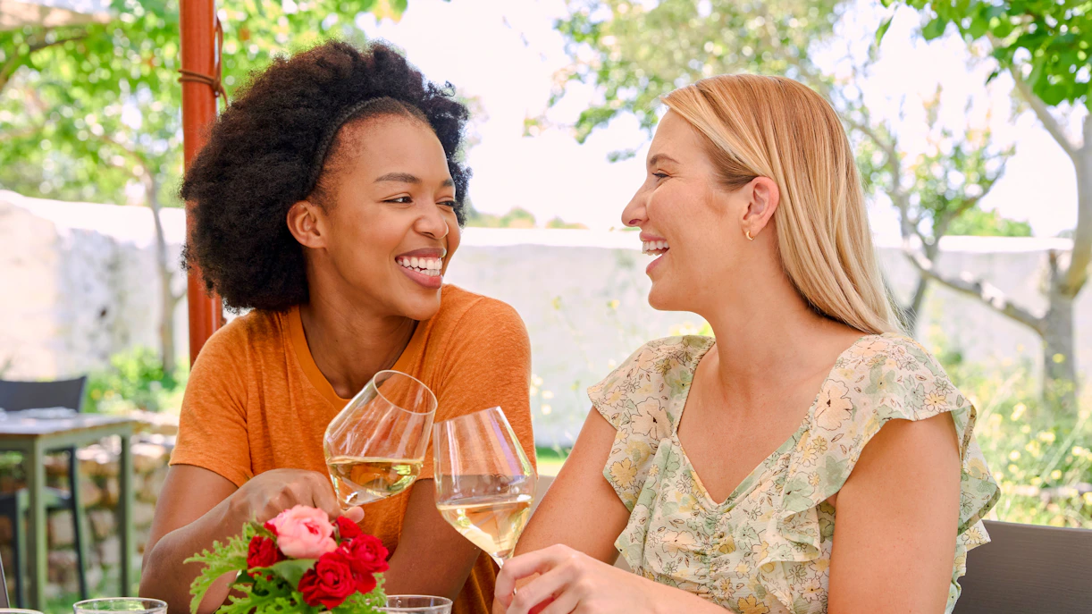 Couple enjoying wine at Vineyard Restaurant table.
