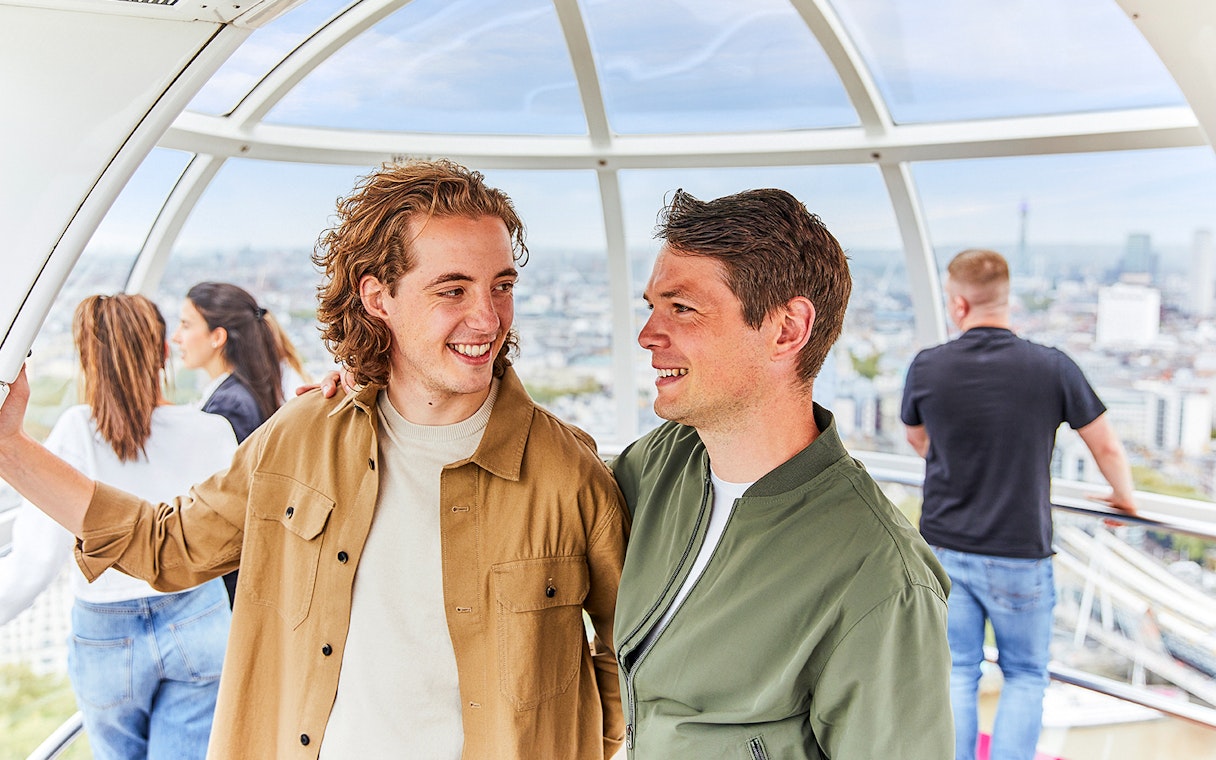 Couple enjoying the view inside a London Eye capsule.