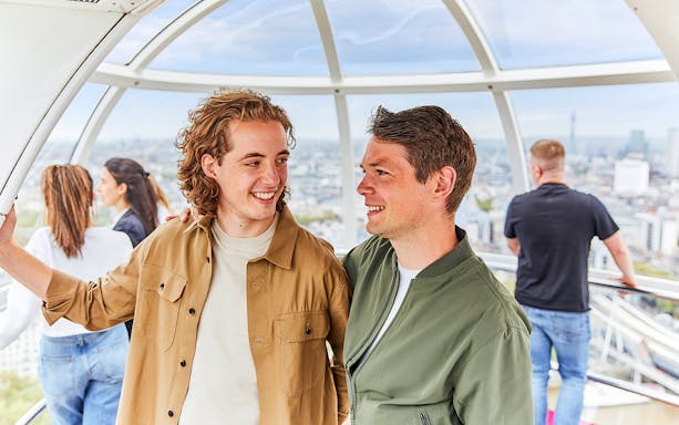 Couple enjoying the view inside a London Eye capsule.