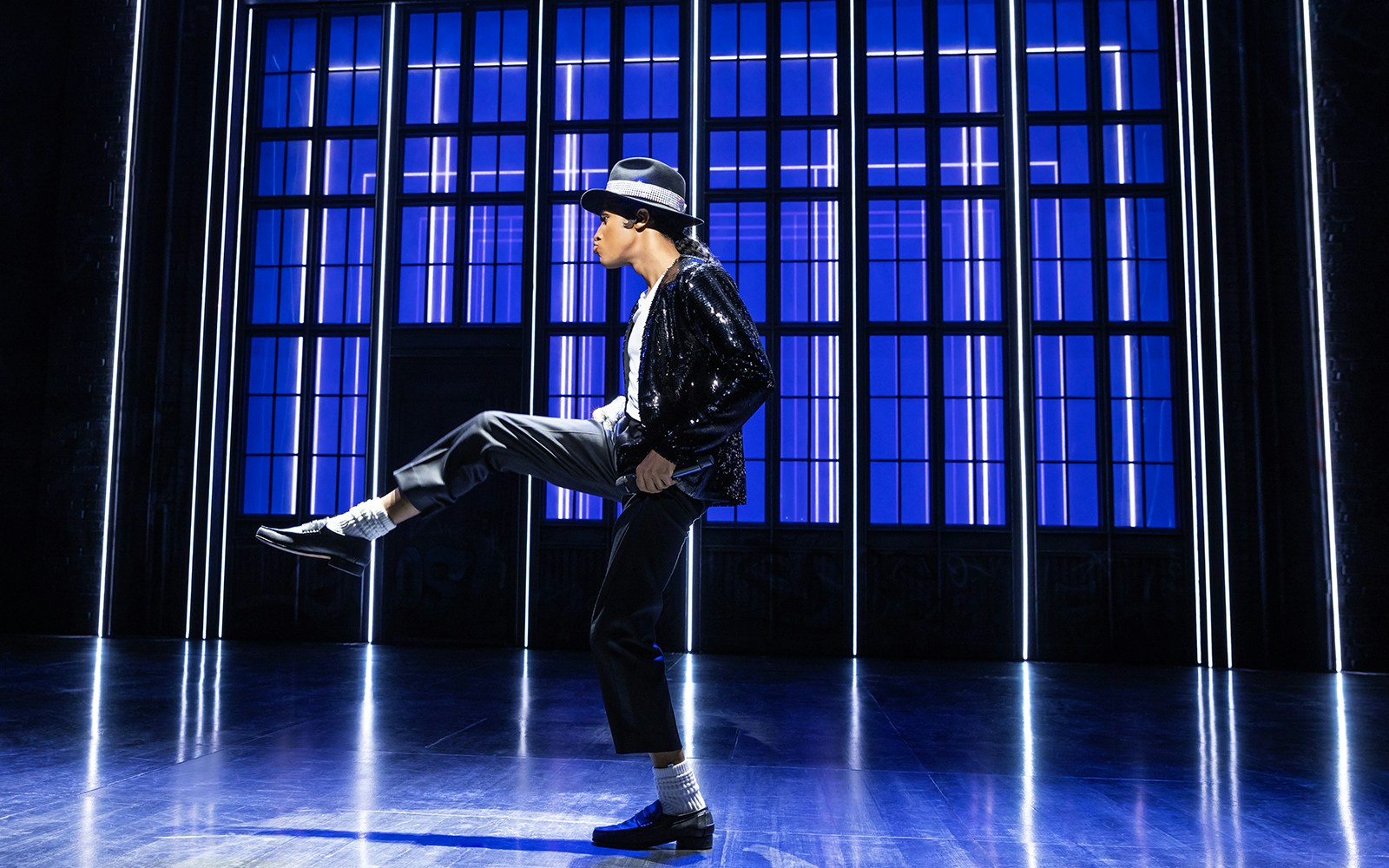 Performer dancing on stage at MJ Live tribute concert.