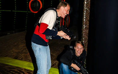 Two people playing laser tag in an indoor arena in Rotterdam.