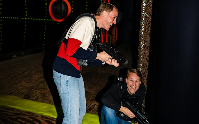 Two people playing laser tag in an indoor arena in Rotterdam.
