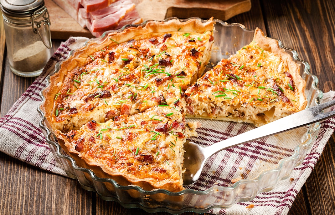 Vegetable tart with herbs in Douro Valley setting.