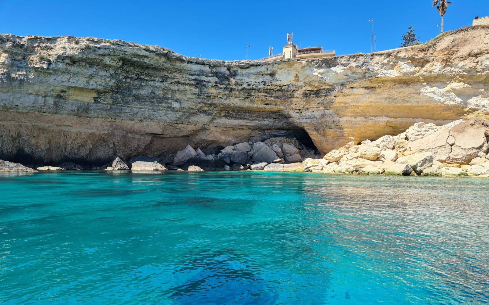Sea cave and rocky cliffs on Ortigia Island boat tour.