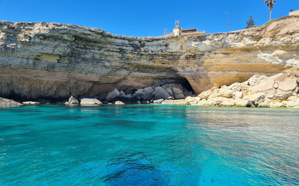 Sea cave and rocky cliffs on Ortigia Island boat tour.