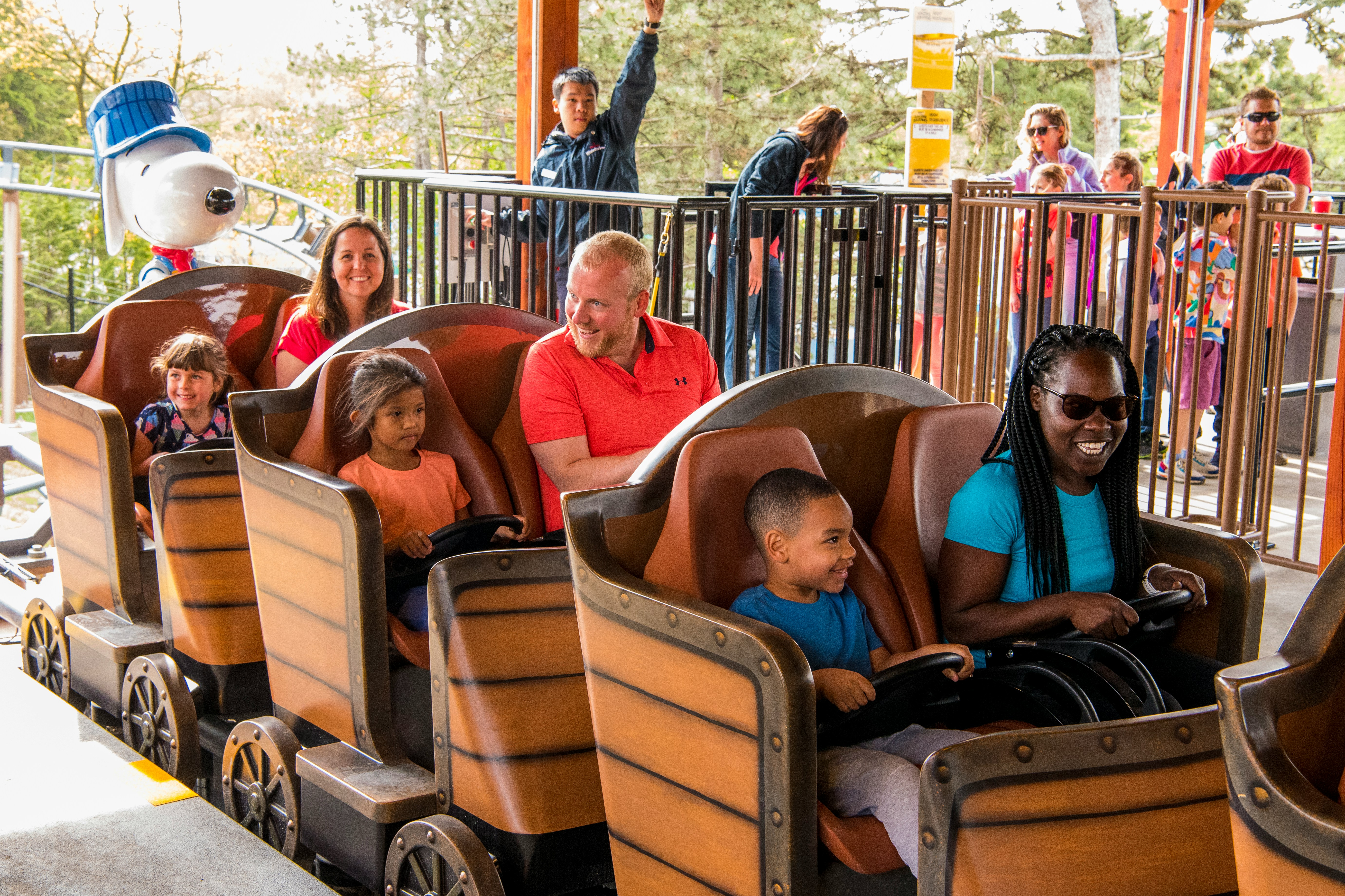 Families enjoying SNOOPY'S® Racing Railway ride at Six Flags Carowinds.