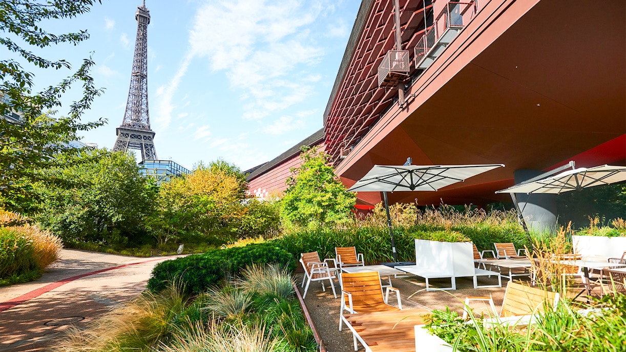Visitors exploring exhibits at Musee du Quai Branly, Paris, showcasing diverse indigenous art and cultures.