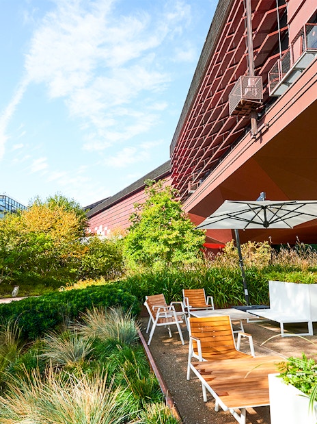 Outdoor seating area at Musee du Quai Branly with Eiffel Tower in the background, Paris.