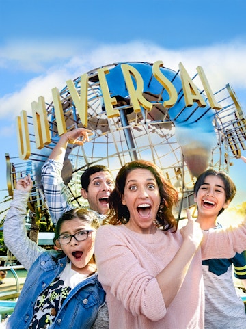 Family taking a selfie in front of the Universal globe at Universal Studios, Los Angeles.
