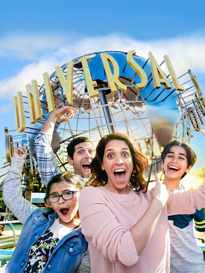 Family taking a selfie in front of the Universal globe at Universal Studios, Los Angeles.