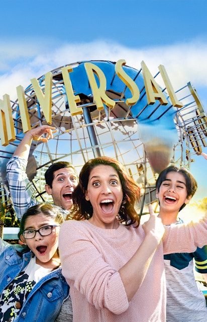 Family taking a selfie in front of the Universal globe at Universal Studios, Los Angeles.