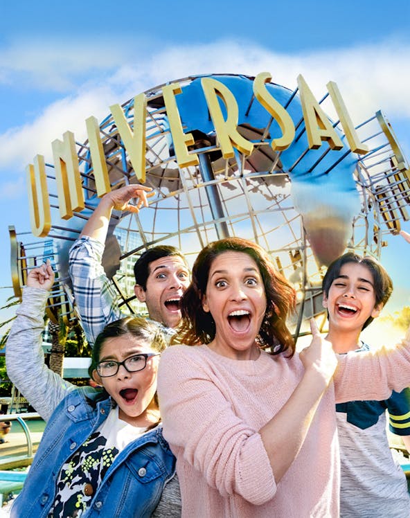 Family taking a selfie in front of the Universal globe at Universal Studios, Los Angeles.