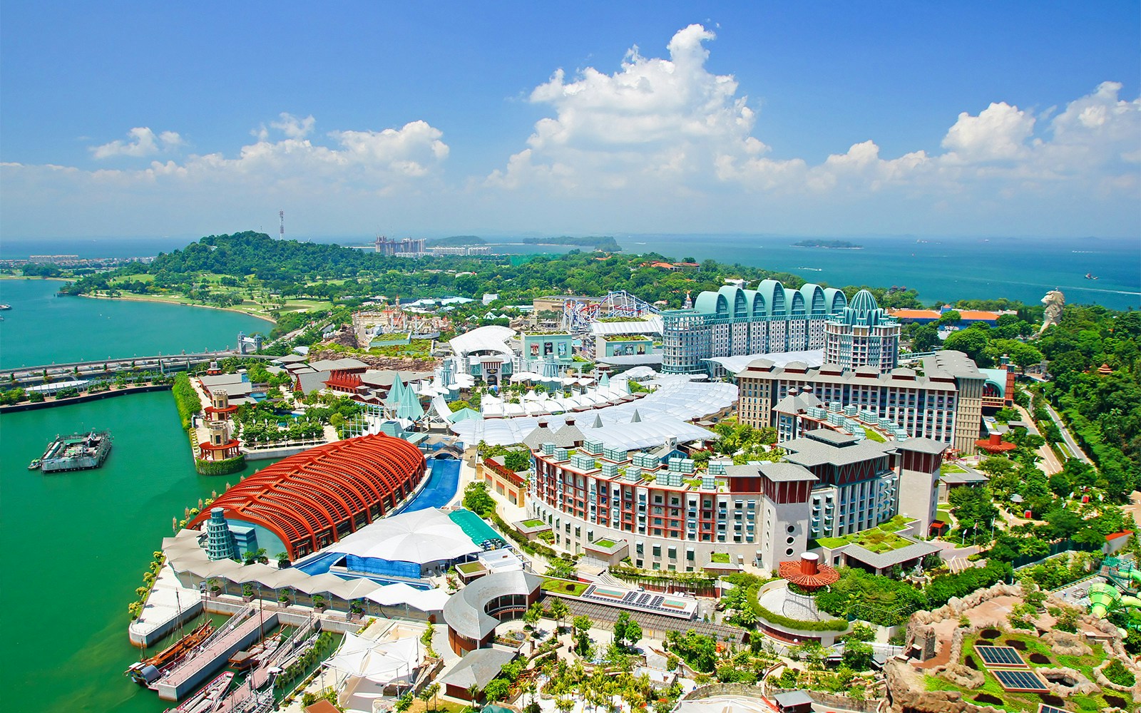 Aerial view of Sentosa Island, Singapore, featuring Resorts World and lush greenery.