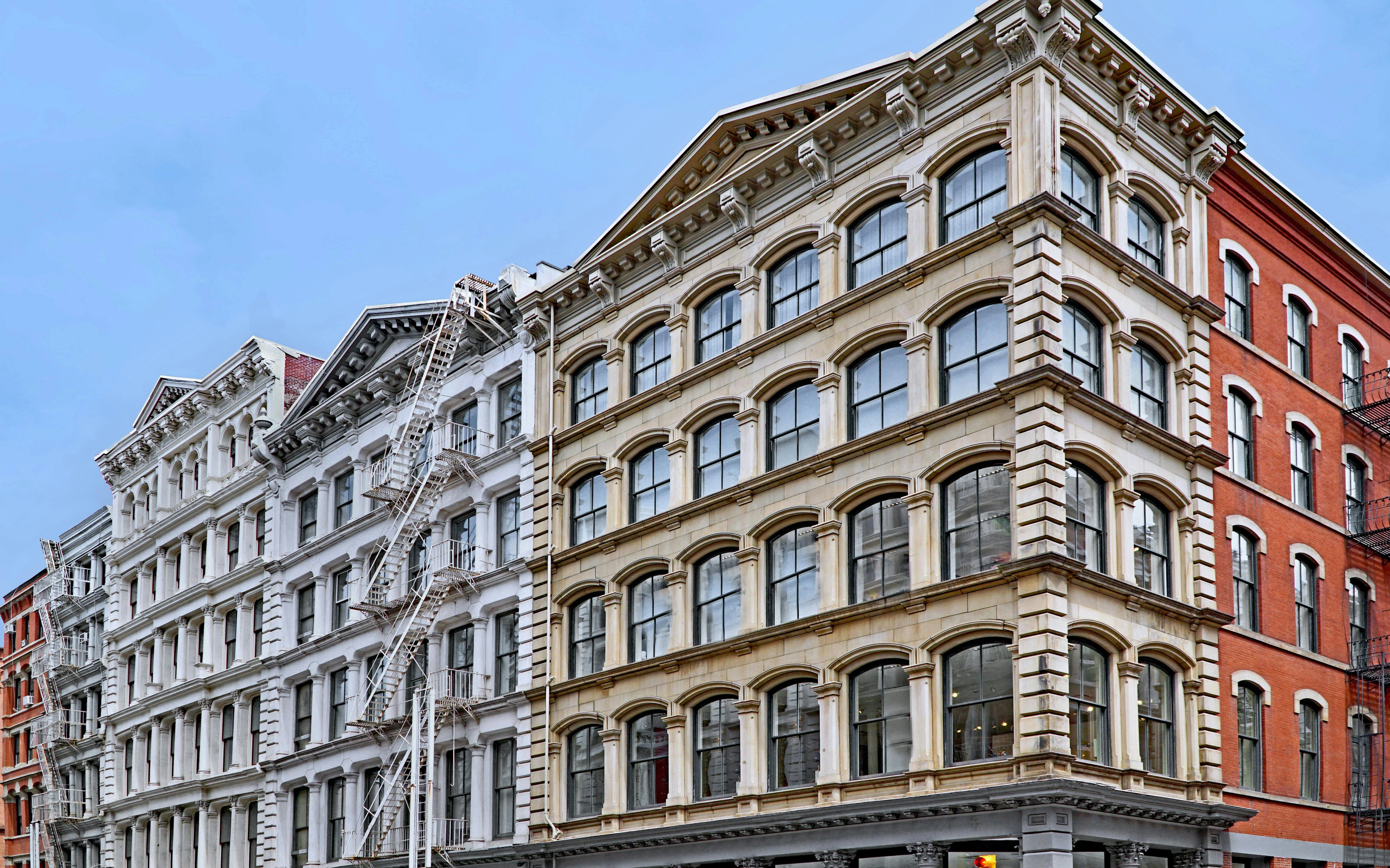 Historic cast iron buildings on Broome Street, SoHo, Manhattan, used as loft apartments and shops.