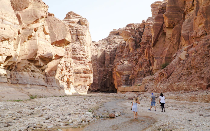 Exploring Wadi al Mujib canyon with rocky cliffs near the Dead Sea, Jordan.